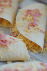 Cooking quesadilla with cheese and ham