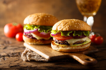Traditional homemade cheeseburgers with lettuce and onion
