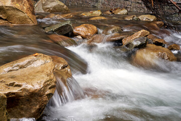 Mountain river with blured water close up