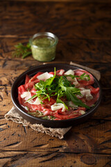 Traditional homemade beef carpaccio with arugula