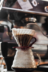 
Arabic coffee filter and hot water that pours in a cafe on a sunny day