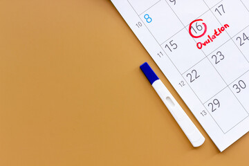 Ovulation home test on calendar with ovulation day red mark