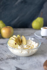 cottage cheese dessert with apples and syrup on a light background