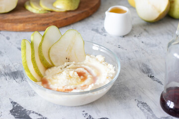 cottage cheese poured with syrup with slices of fresh pear