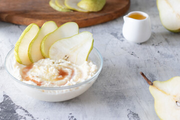 Fototapeta na wymiar cottage cheese poured with syrup with slices of fresh pear