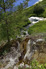 Fototapeta na wymiar In the fault of the gypsum mountain Karavai (Loaf), the Sudinka River disappears.