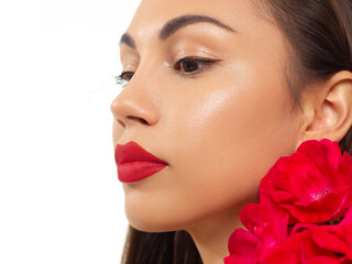 Fototapeta premium Beautiful woman with bright make up eye with sexy pink liner makeup. Fashion arrow shape on woman's eyelid. Natural lips. Chic evening make-up. Luxurious long wave hair. Shining face skin with flowers
