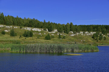 Rocky outcrops of white gypsum along the banks.
