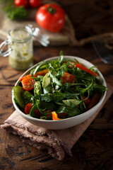 Healthy arugula salad with tomato and cucumber