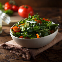 Healthy arugula salad with tomato and cucumber