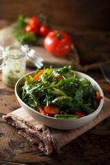 Healthy arugula salad with tomato and cucumber