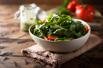 Healthy arugula salad with tomato and cucumber