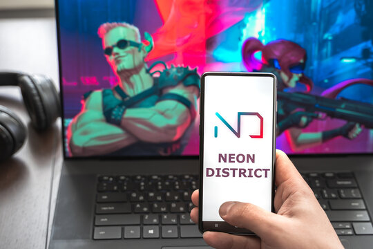 Russia Moscow 30.05.2021.Logo,screenshot of blockchain nft ethereum cryptocurrency kiber punk game Neon District in laptop, mobile phone. Man playing, collecting cards. Earning tokens,digital money