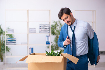 Young male employee in business relocation concept