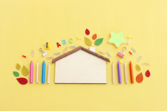 Back to school concept. Top view image of student stationery over pastel yellow background