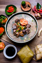Fototapeta na wymiar Coto Makassar is a traditional food of Makassar, Indonesia. This food is made from boiled offal (stomach contents) in a long time and seasoned with specially formulated spices