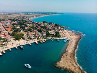 Aerial view of the bay, ships and boats. Touristic place, ancient buildings, the Colosseum and the Temple of Apollo. Turkey, Manavgad, Side.