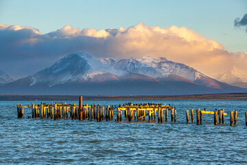 Sunrise over a landscape with fjord and abandoned pier at Puerto Natales in southern Chile
