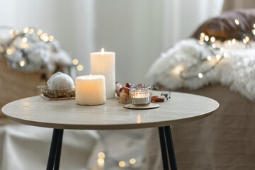 Cozy room interior with garlands, candles and a Christmas atmosphere.