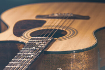 Obraz premium Close-up of a classical acoustic guitar on a black background.