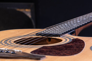 Fototapeta premium Close-up of a classical acoustic guitar on a black background.