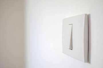 white lighting switch on concrete wall