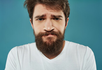 Fototapeta premium emotional man in a white t-shirt hand gestures anger Studio