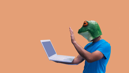 person with frog mask gesture holding a streaming video conference and greeting webminar session participants on orange background