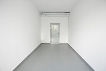 Empty white room with light walls.