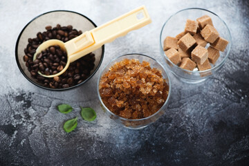 Bowl of coffee granita and some of its ingredients over dark-grey stone background, elevated view, horizontal shot