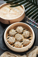 Bamboo steamer with panasian soup dumplings, vertical shot, selective focus