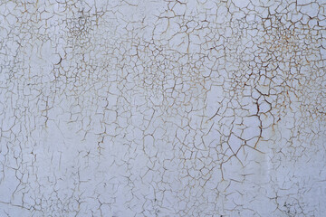 Painted in white old cracked metal rusted background. Metal rust texture. Erosion metal. Scratched and dirty texture on outdoor rusted metal wall.