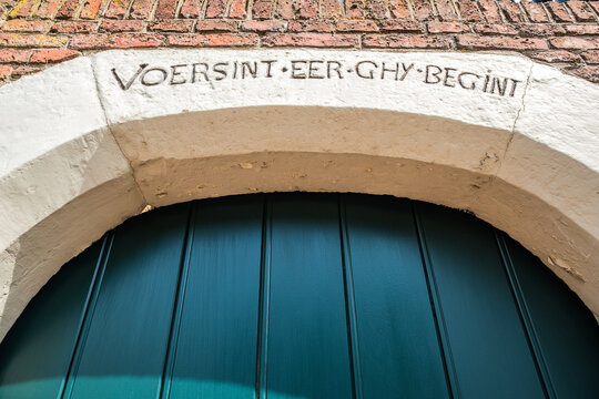 Inscription "Versint eer ghy begins" above gate next to the Planetarium in Franeker, Friesland Province, The Netherlands