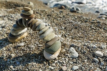 Fototapeta na wymiar Balancing sea stone on beach background