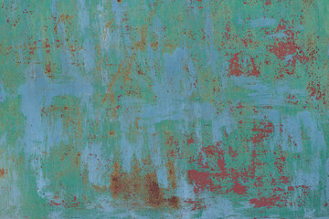 Painted in green old cracked metal rusted background. Metal texture. Erosion metal. Scratched and dirty texture on outdoor metal wall.