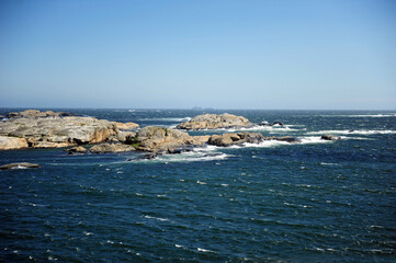 Beautiful seascape with tiny islands. Horizontal photo with copy space. Sunny and windy weather.
