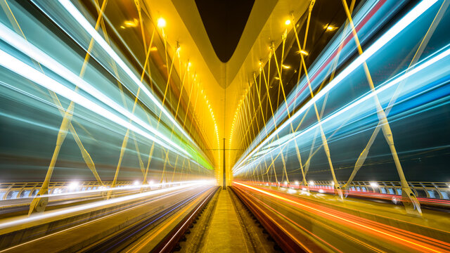 Moving trams on the Troja bridge (Trojsky most) in the misty evening in Prague, Czech republic.