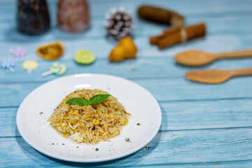 The brown soy sauce egg fried rice looks appetizing on the dining table.