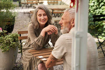 Fototapeta premium Spouses feeling great while enjoying of they romantic date at the summer cafe