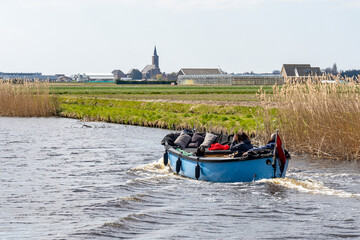 Obraz premium From a boat you have a beautiful view of the many fields with blooming flower bulbs near Lisse, the Netherlands