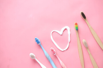 tooth brush and paste on pink 