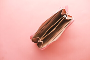 empty wallet on pink background , top view 