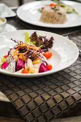 Bowl of healthy fresh fruit salad  with sauce

