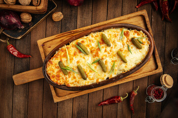 Georgian baked beef stew under cheese with pickles