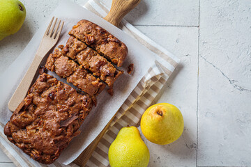 Pear bread on a wooden board. Autumn fruit pie, gray background