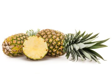 Fresh yellow pineapples with leaf on white