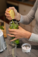 Close up of caucasian woman in kitchen, preparing health drink