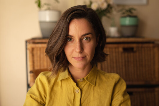 Portrait Of Smiling Caucasian Woman In Living Room Looking At Camera