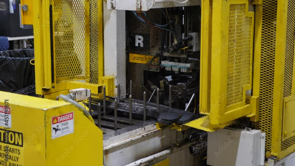 Poster machine stacking parts on an assembly line