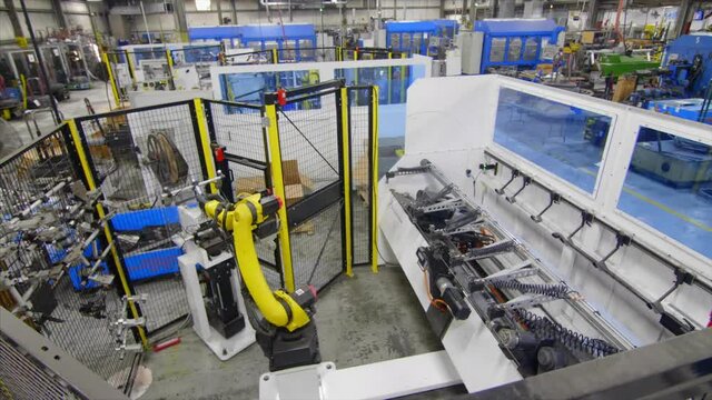 An industrial robot arm performing it's full cycle of operations